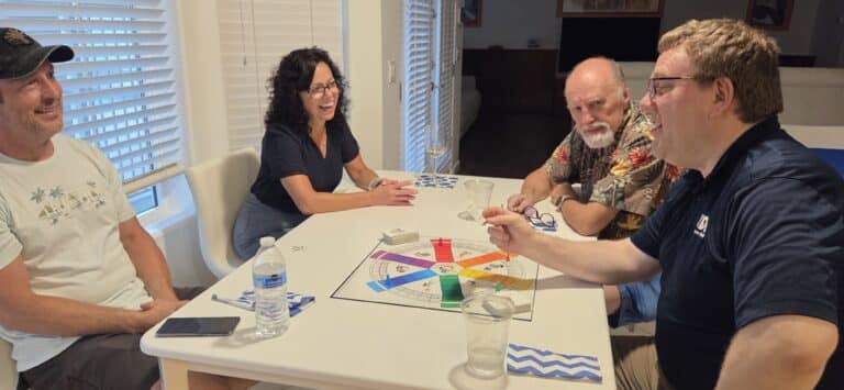 People smiling and playing the Company Culture Board Game